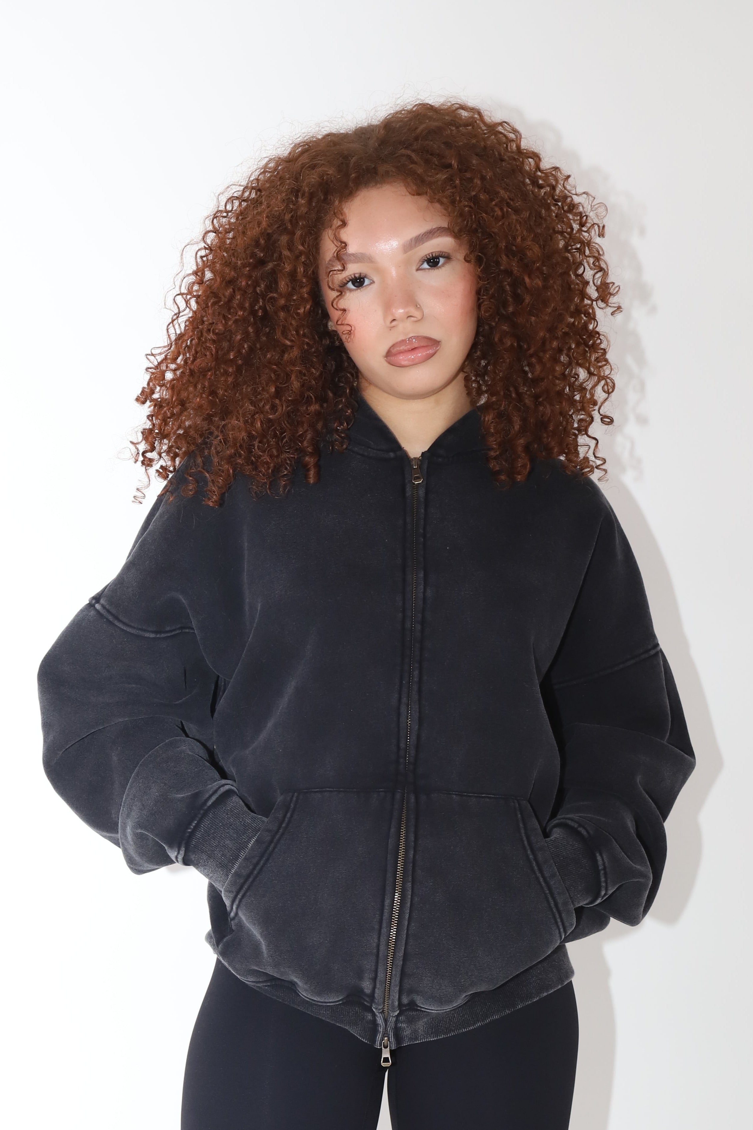 Washed black fleece zip-up hoodie – vintage-inspired faded finish for a lived-in look – oversized fit for effortless layering – ultra-soft fleece interior for warmth & comfort – ribbed cuffs & hem for a snug feel – front pockets for functionality & style – perfect for everyday wear, from lounging to running errands-acid wash hoodie-oversized-acid wash